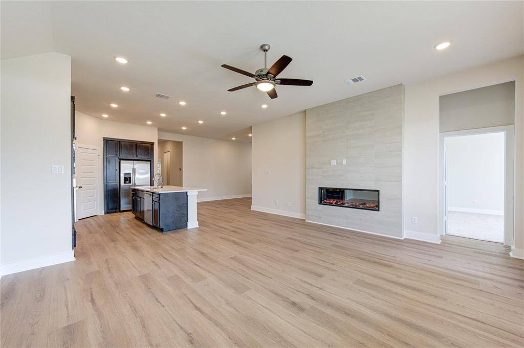 Light and bright with high ceilings, can lighting, modern fireplace and room to gather.