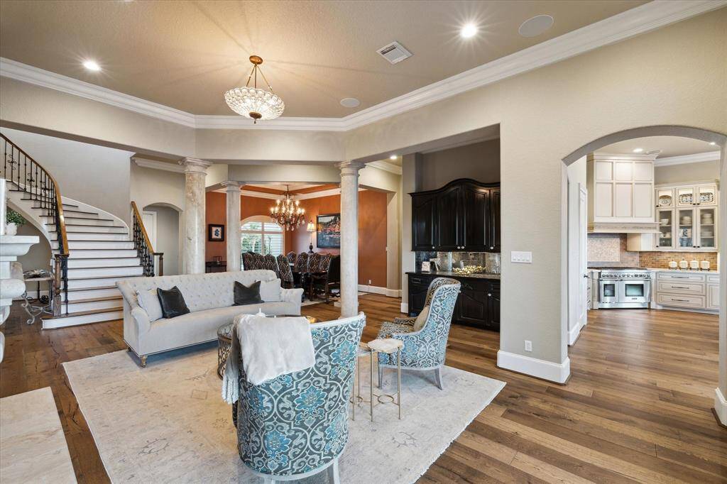 THE BUTLER'S PANTRY AND WINE CLOSET LOCATED PERFECTLY BETWEEN THE FORMAL LIVING AND DINING ROOMS.  THE ARCHED ENTRY TO THE RIGHT OPENS TO THE KITCHEN AND DEN.