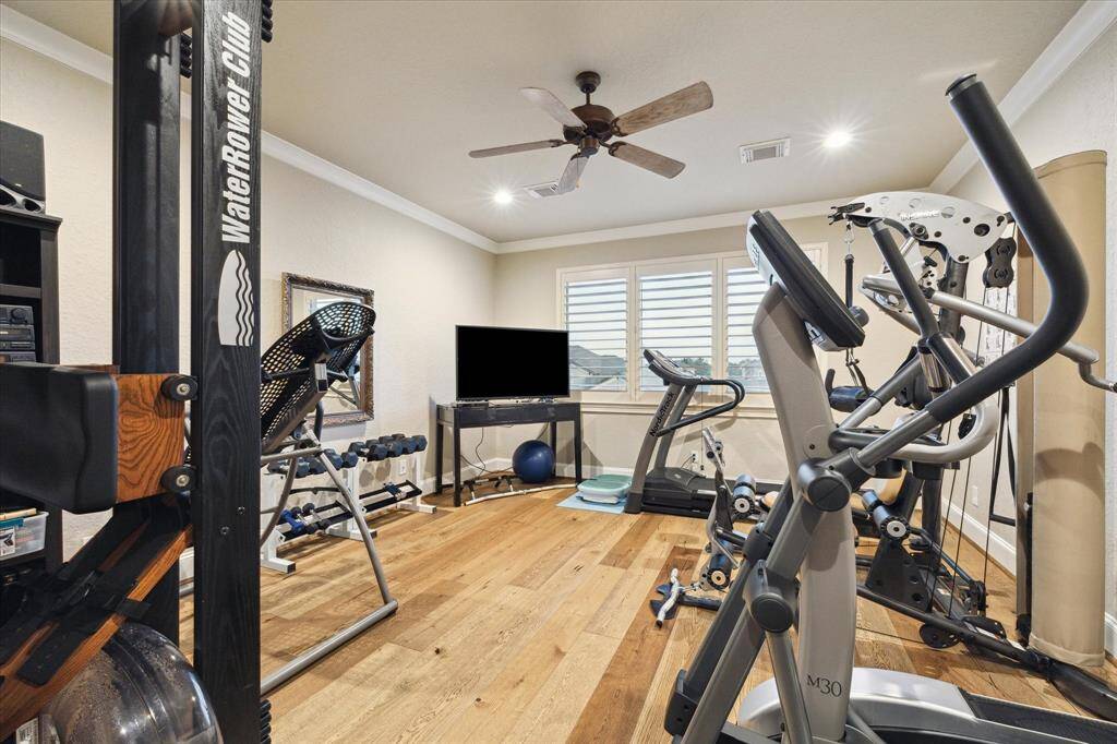 MEDIA ROOM OR EXERCISE ROOM WITH OAK WOOD FLOORS AND A PRIVATE ENTRANCE.