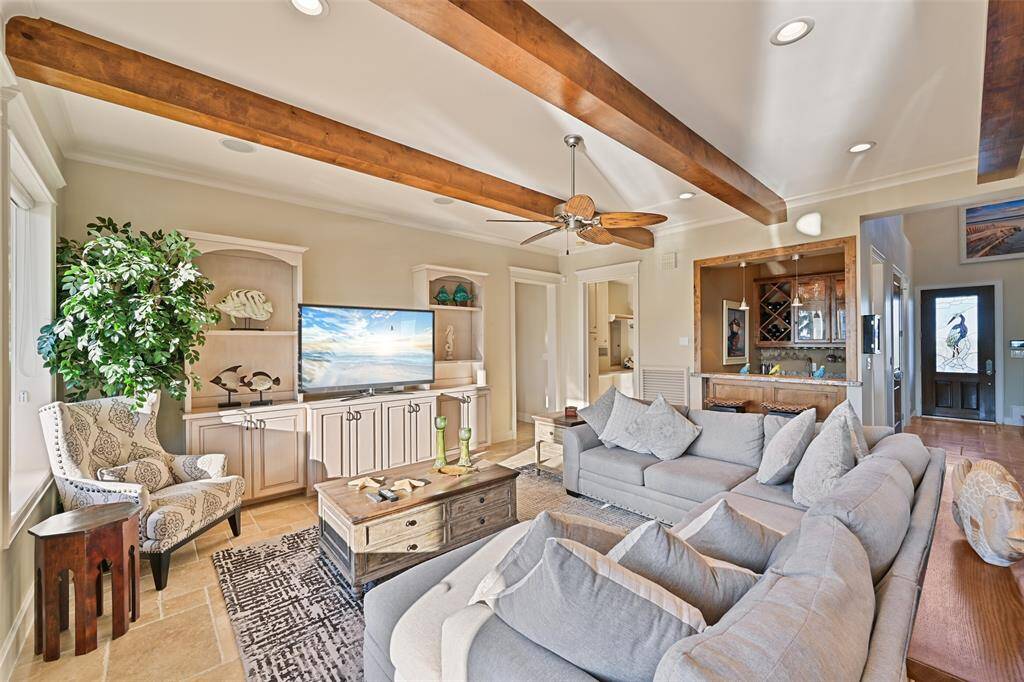 Living room... notice the elegant stain glass front door in the background