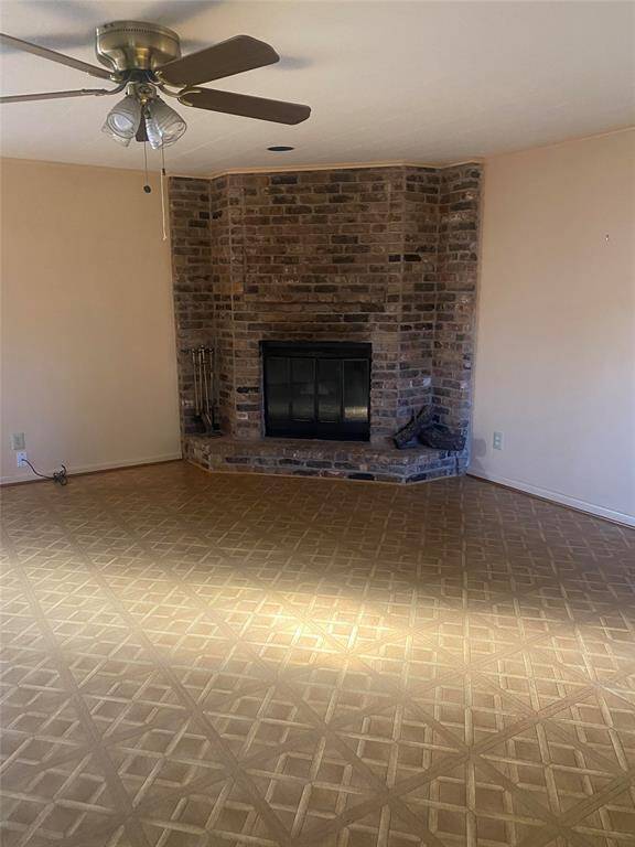 Oversized den with fireplace. Lots of light throughout.