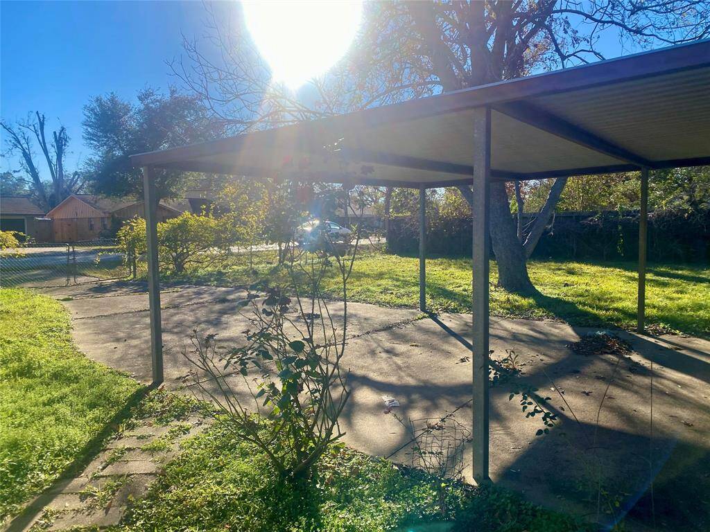 There are two vehicle access ramps to the property, from each corner. The one in the photo with carport for two.