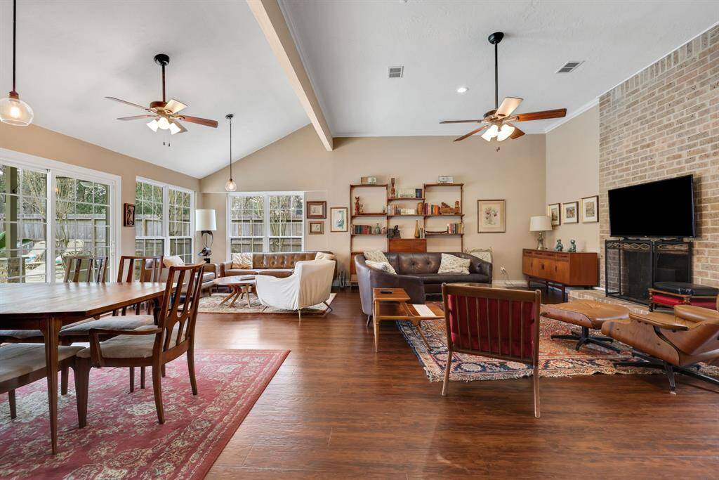 Great family room with a fireplace tall ceilings and a great view of the pool.