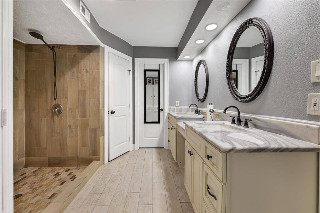 Primary en-suite with an extensive shower and dual sinks.