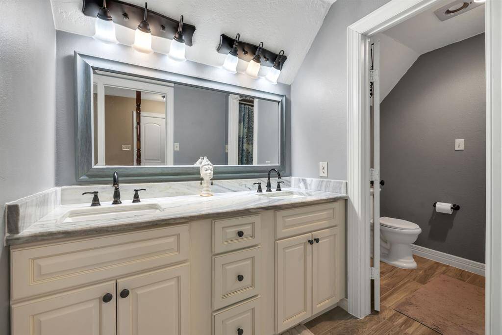 Secondary bathroom upstairs featuring double sinks and tub shower combo.