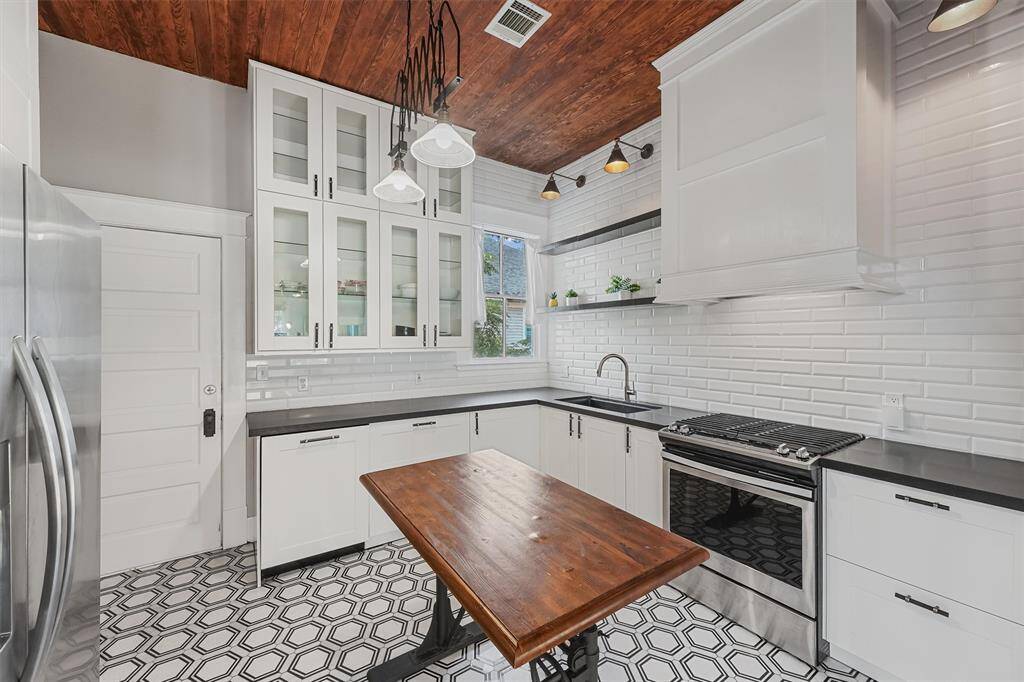 Fully updated kitchen features stainless steel appliances, subway tile, shiplap ceilings, and plenty of storage space!
