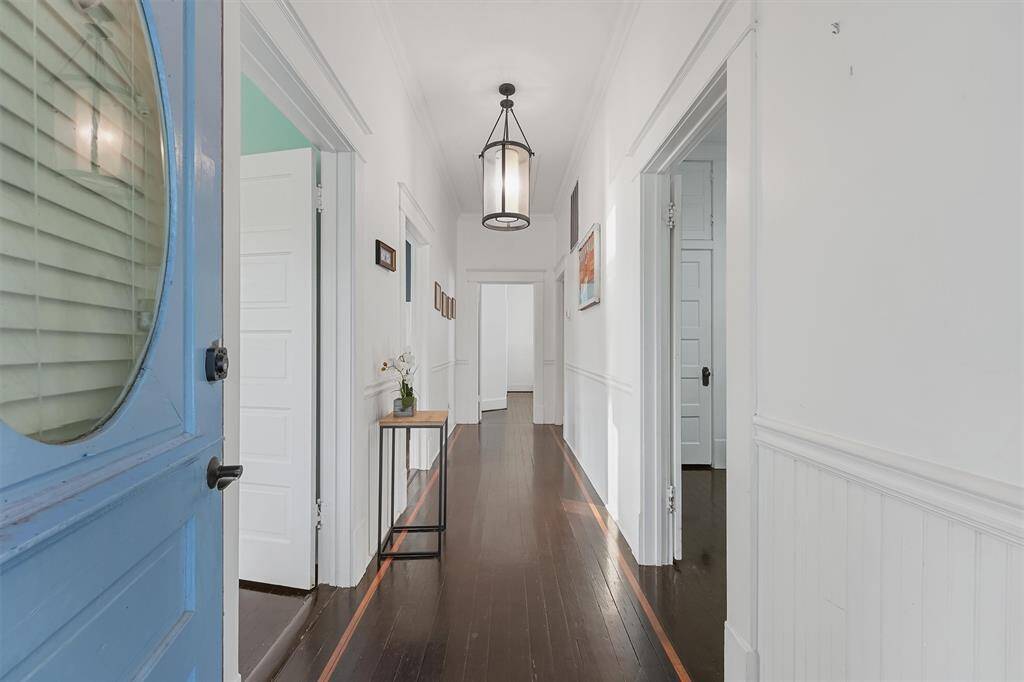 As you enter you are greeted with tall ceilings and hardwood floors