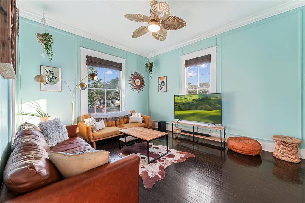 The living room offers plenty of natural light with bohemian decor