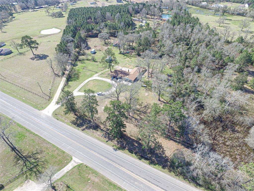 Home sits back off the highway and features circle drive with back of the property fenced for your livestock or horses.