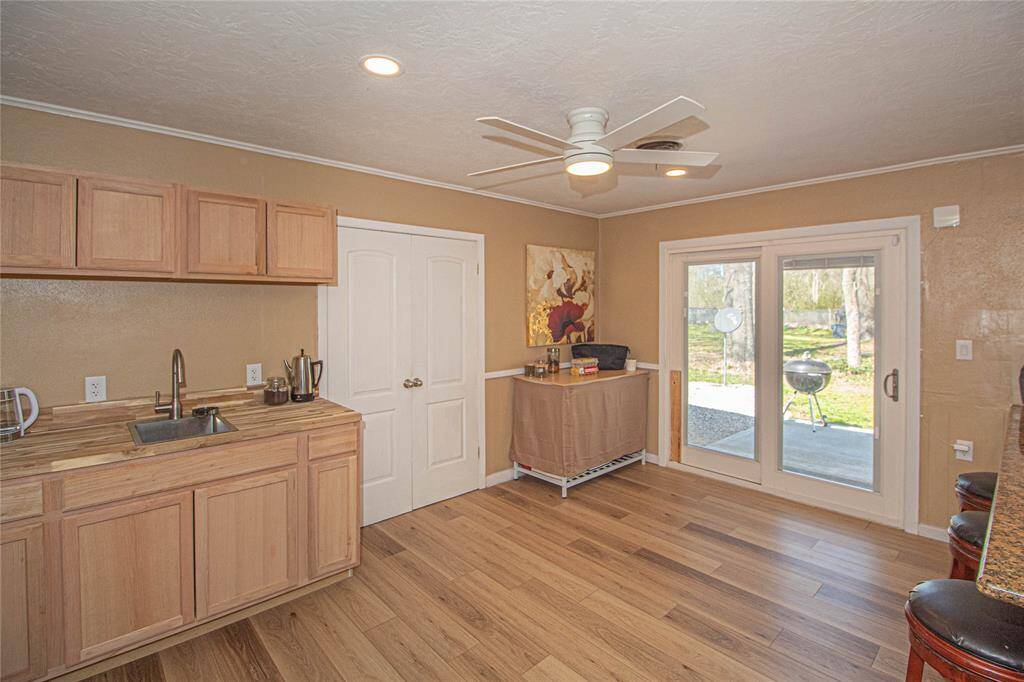 Kitchen features beautiful cabinetry; spacious laundry room and French Doors lead out to another patio for you to relax and enjoy quiet time.