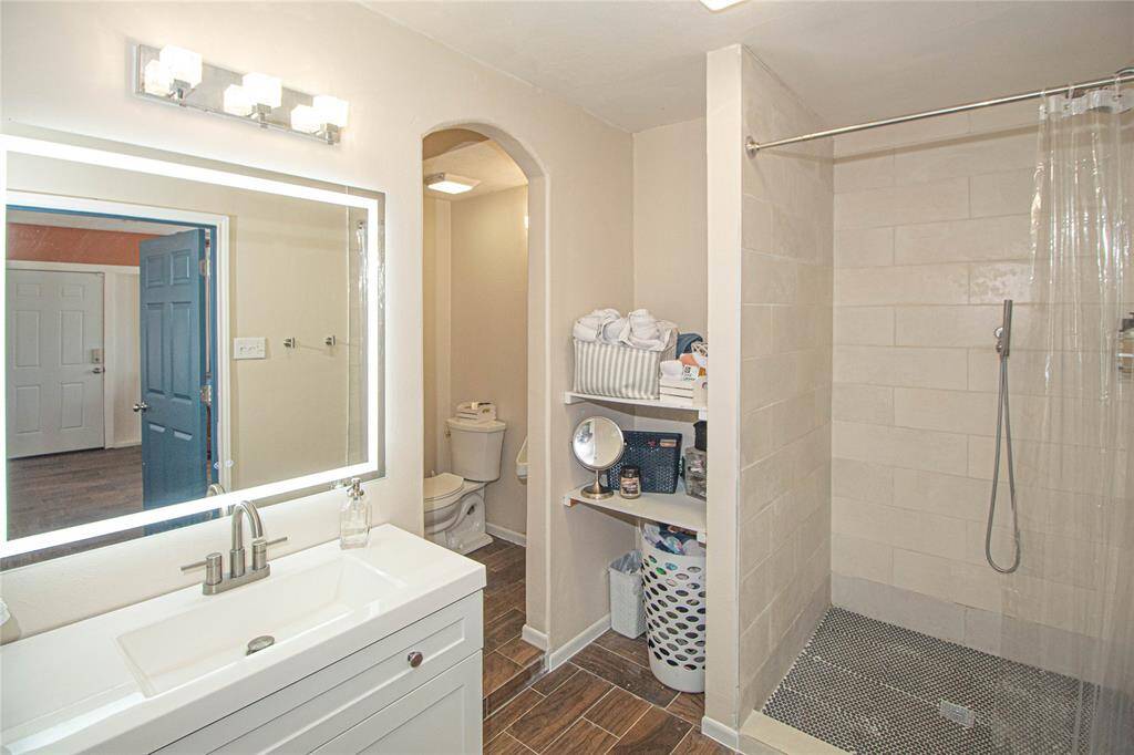 Primary bath features walk in shower, closet area and separate water closet