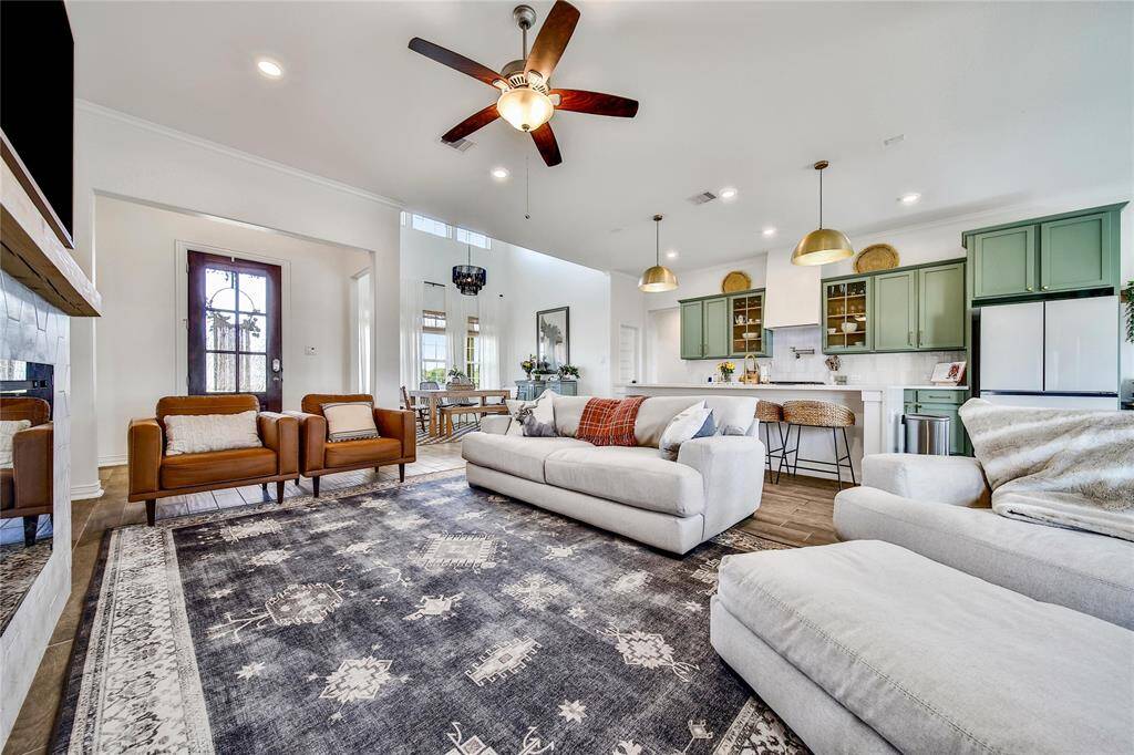 This photo is taken in my living room looking towards my kitchen. In the foreground is my home's kitchen island, and the cabinets are in the background.