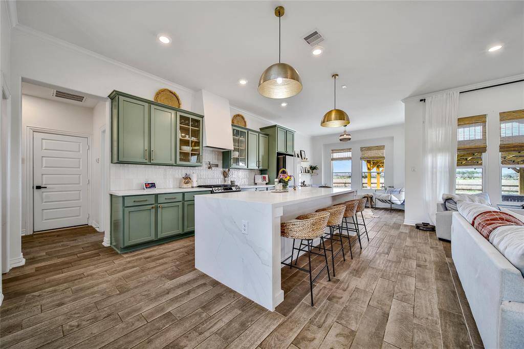 View of kitchen from dining room, including the garage door.