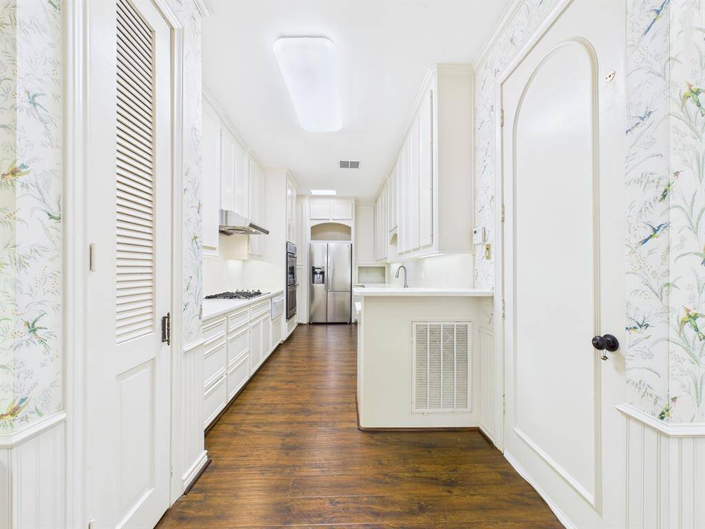 Galley Style Kitchen.  Door to the right leads to the home elevator and pass through to the two-car garage