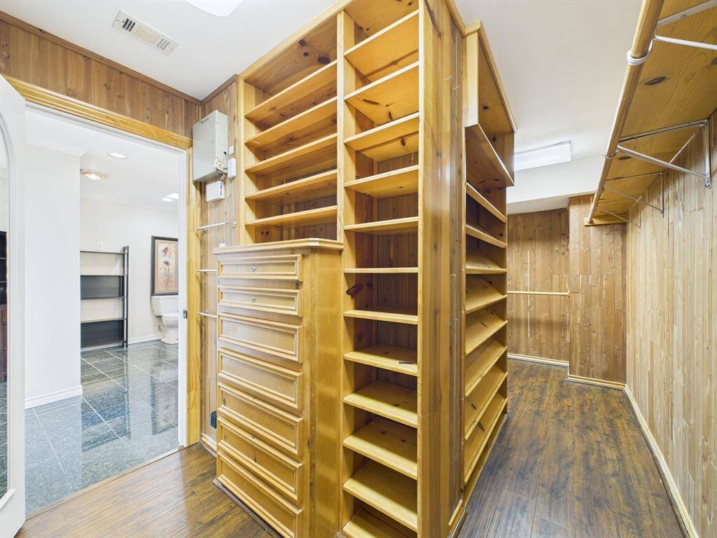 Custom cedar walk-in with built-ins for jewelry, watches, shoes and more