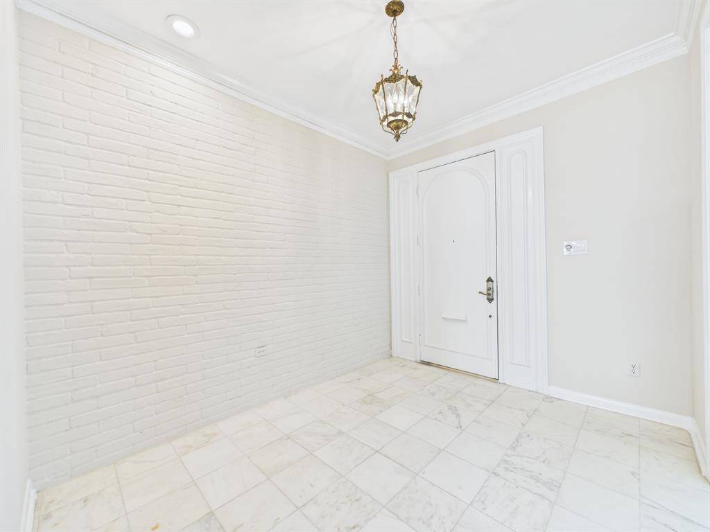 Formal Entry boasting High Ceilings, Exposed Brick and Marble Flooring