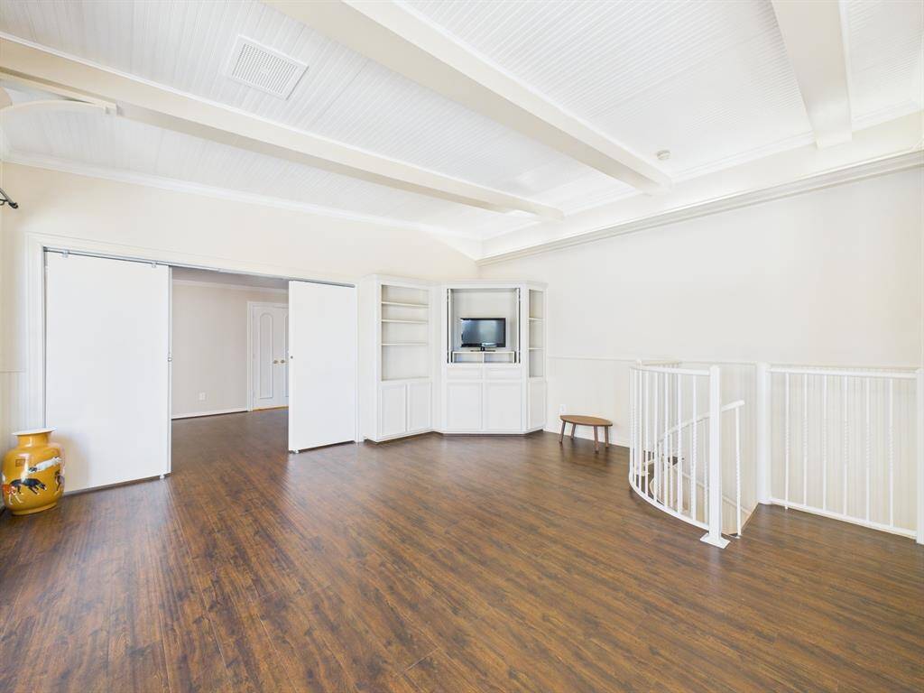Built-in entertainment unit and spiral staircase down to the breakfast room