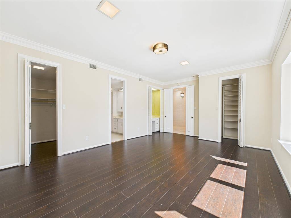 Generous primary bedroom with two large walk-in closets, primary bath and vanity/study Area