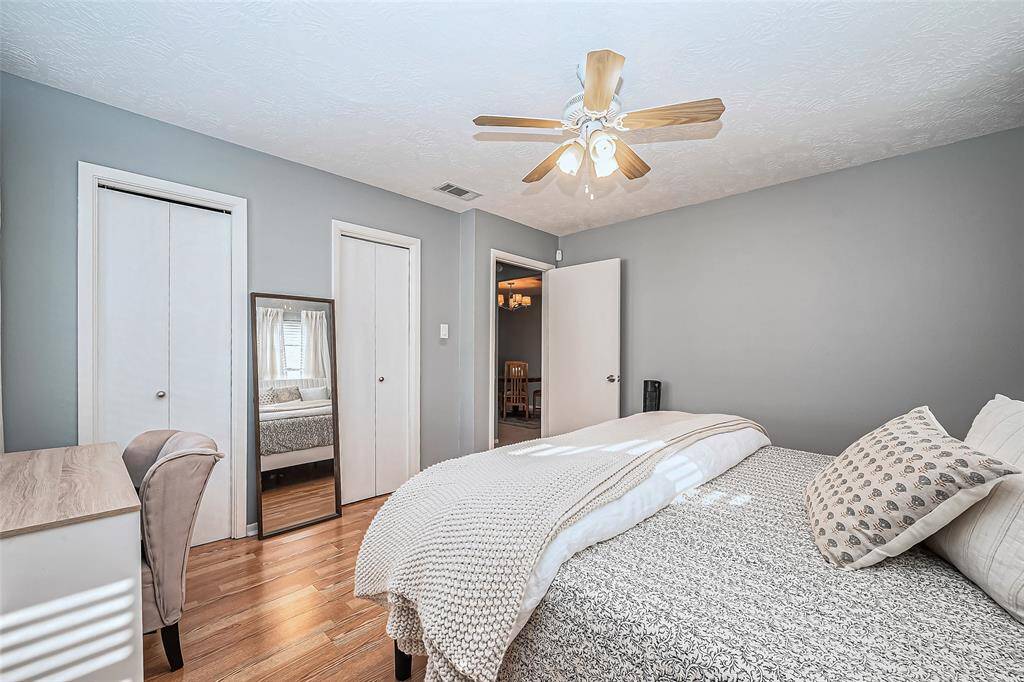 Side view of primary bedroom with double closet space.