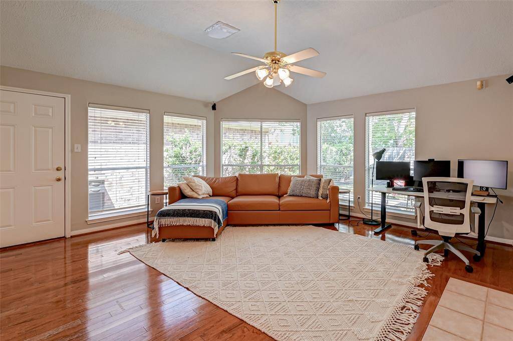 Wall of Windows Highlight the Den with Lots of Natural Light!
