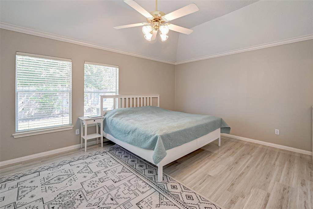 Spacious Primary Bedroom with Easy to Maintain Tile Floors, High Ceiling & Ceiling Fan!
