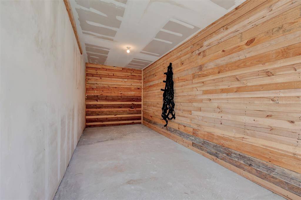This is a GREAT extension of the garage!  It also opens to the pool area.  This can be used however you need!  Workshop, pool toys, storage...
