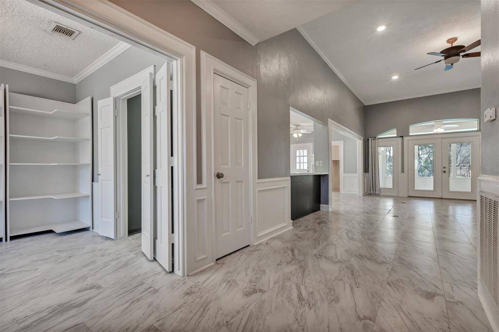 A view from the entry...formal dining (left), family room ahead with wall of windows and doors for great light!