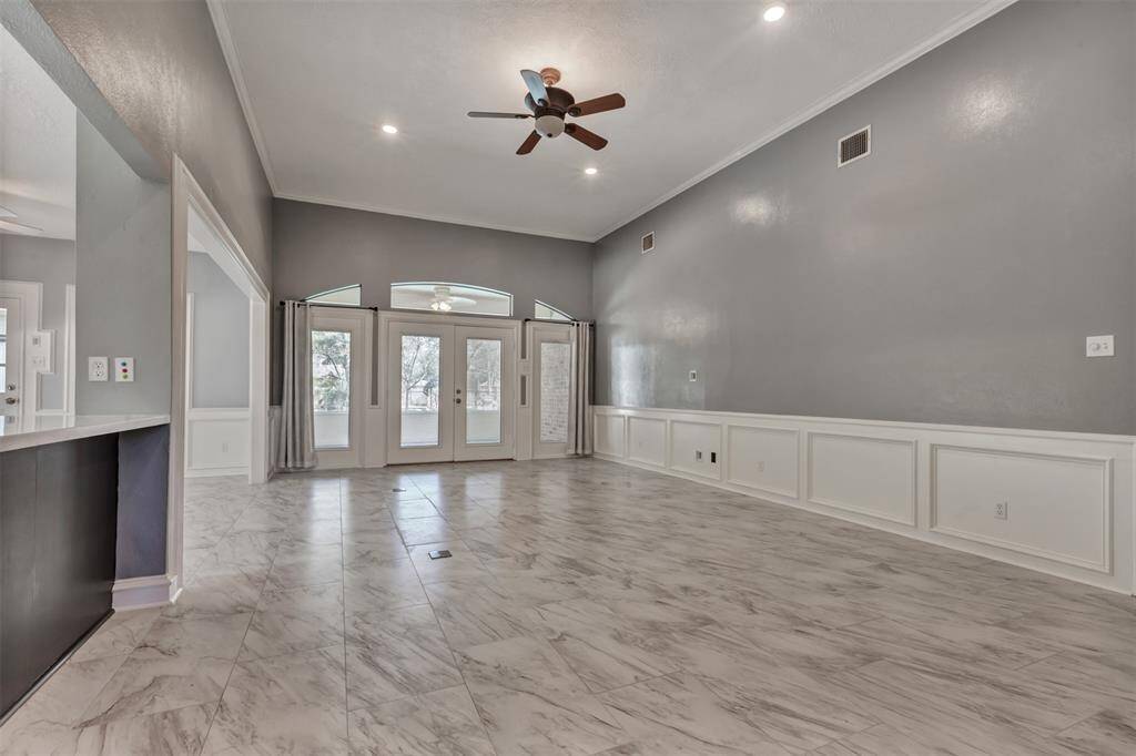 High ceilings, light color palette, wainscoting and tile bring this space together with plenty of natural light and space to arrange your furniture.