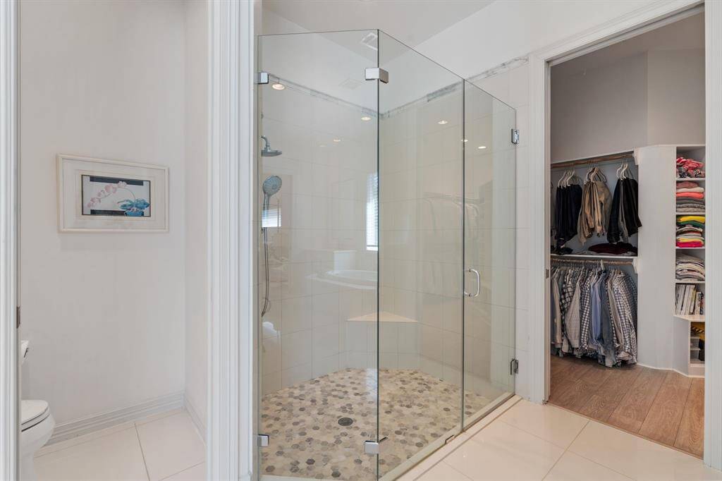 The primary bathroom has a walk in shower with a pebble tile floor.