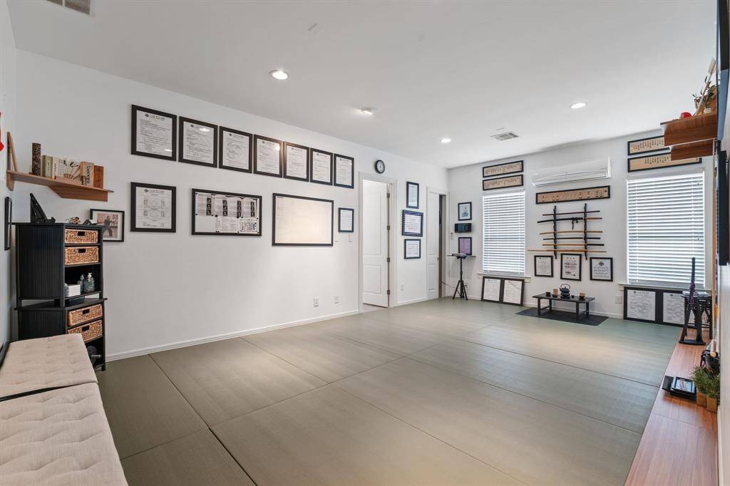 Spacious room with convenient access from the garage. Ideal for a home gym, office, or hobby space.