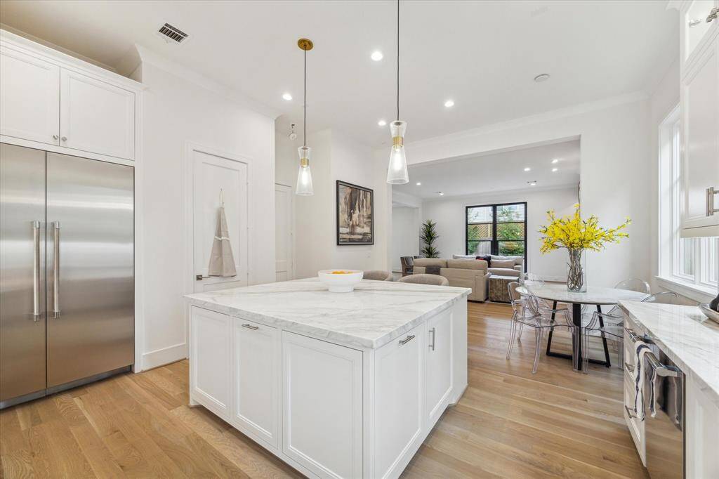 The Kitchen features a broad Island, plus a walk-in Pantry.