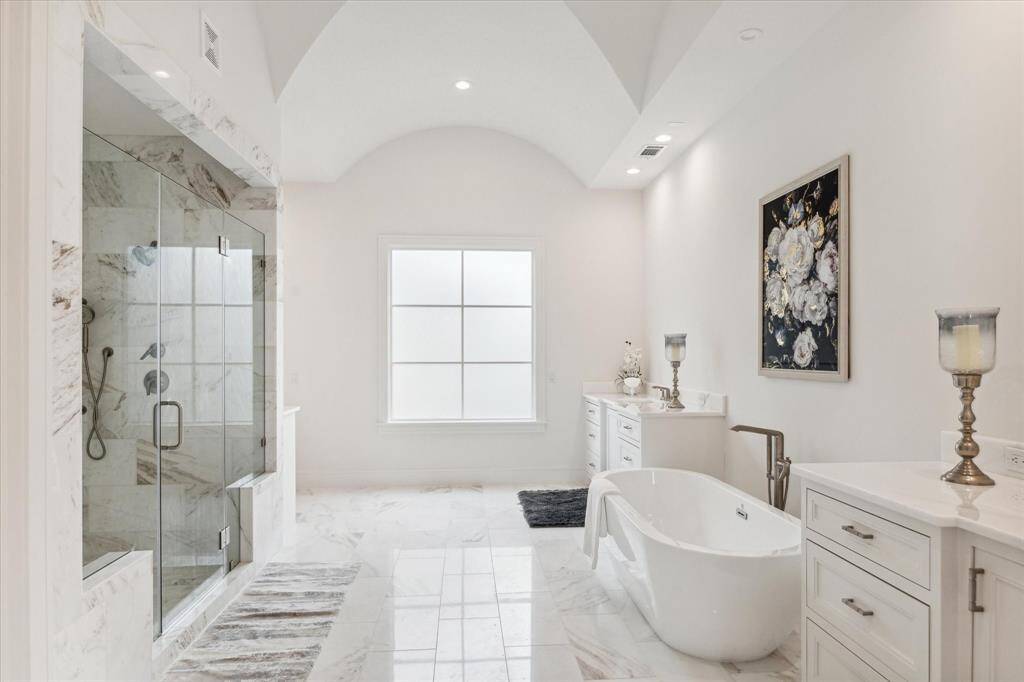 'Sumptuous' is the best way to describe the royal-sized Master Bath.  From the groin vault ceiling, to the dual, marble topped custom Vanities, to the Slipper Tub, to the private Water Closet, to the supremely generous Shower--one sight of the luxury within will steal your breath.
