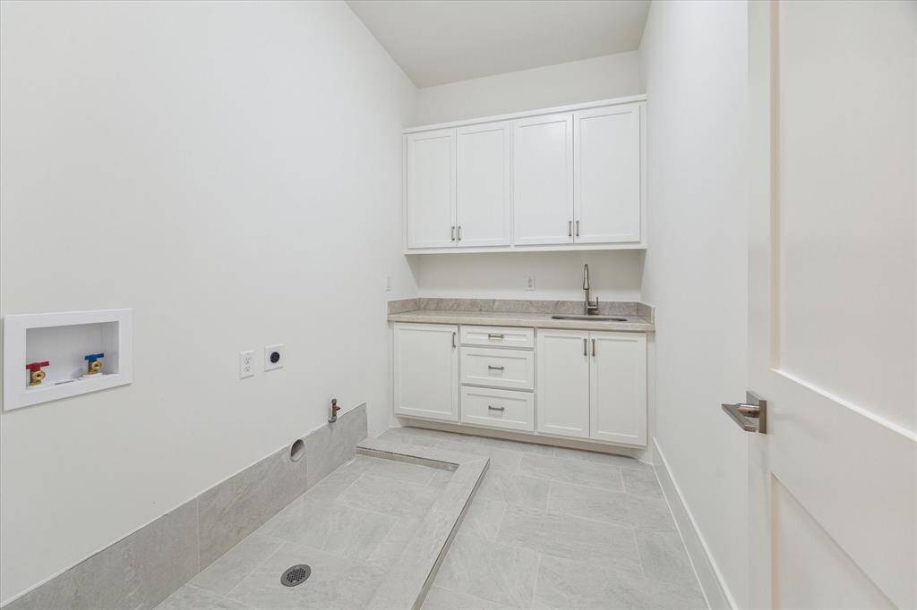 Those with dirty laundry may send it here to be cleaned! The Utility Room features custom Cabinets, a soaking Sink and space for a top load or front load Washer, and a Gas or Electric Dryer!
