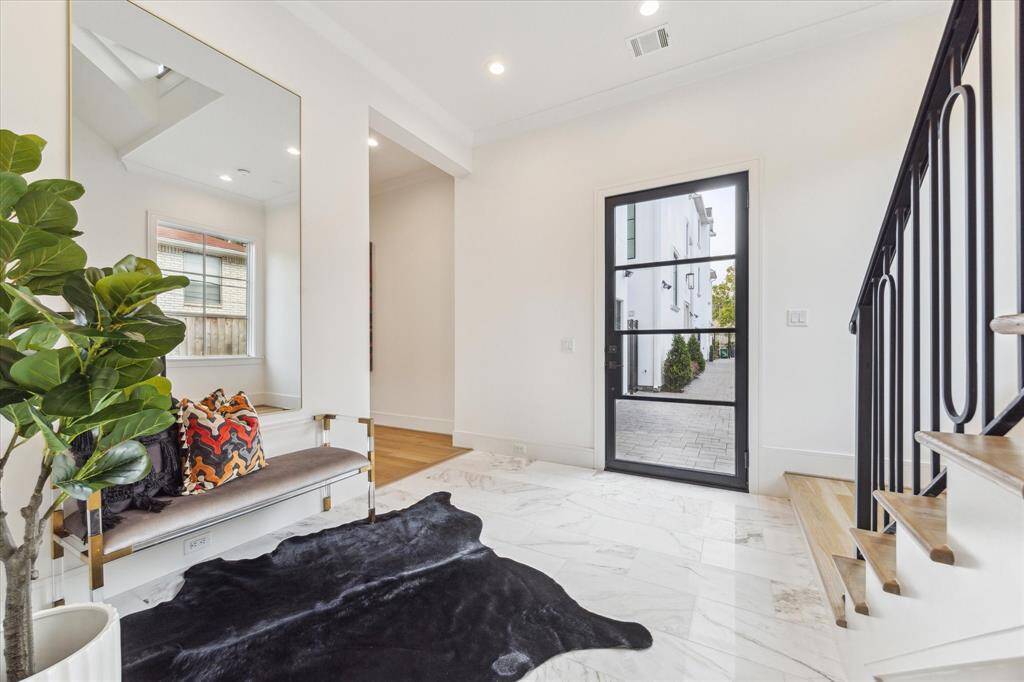 The Entry is set in a three story tower which allows light to travel from the sky down through the three floors causing these marble tile floors to glimmer.
