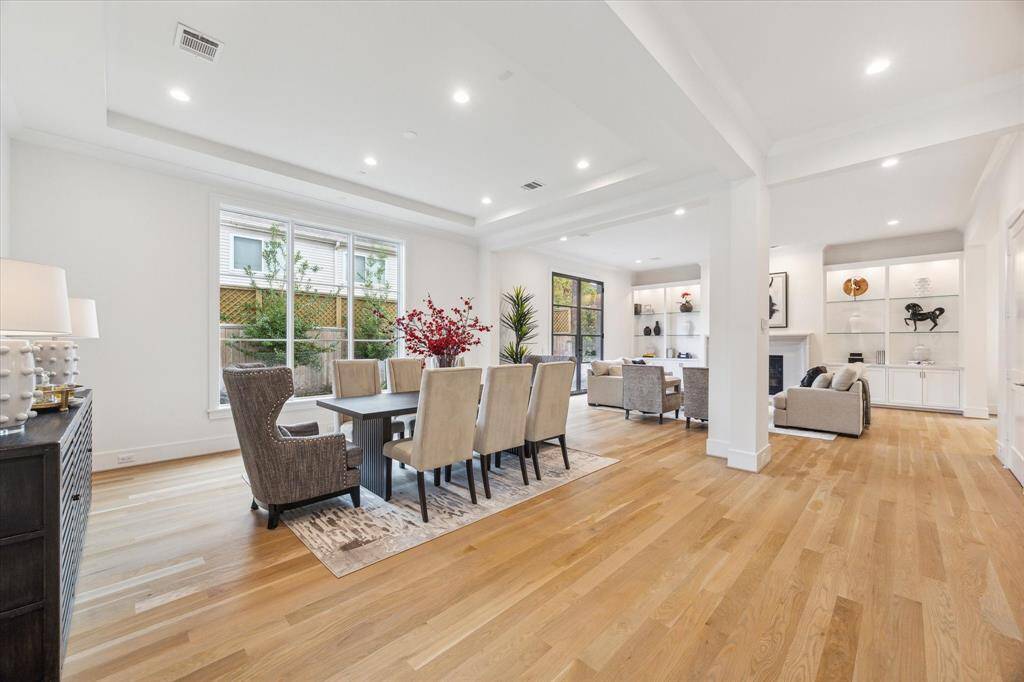 Upon moving to the living areas, the first scene is the Dining Room, with wood floors, a cove ceiling and a view of the large rear Garden. This space is the best of open concept living with defined spaces.