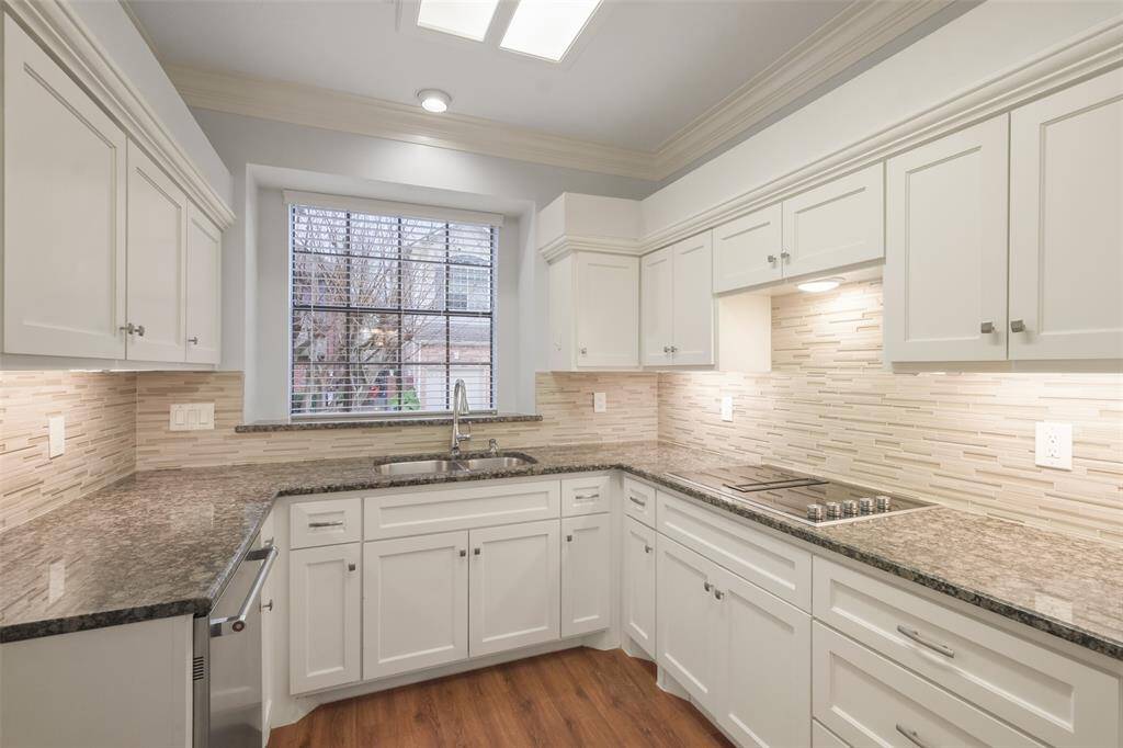 A closer look at the kitchen, featuring an electric range and a sink perfectly positioned to offer scenic views of the outdoors.