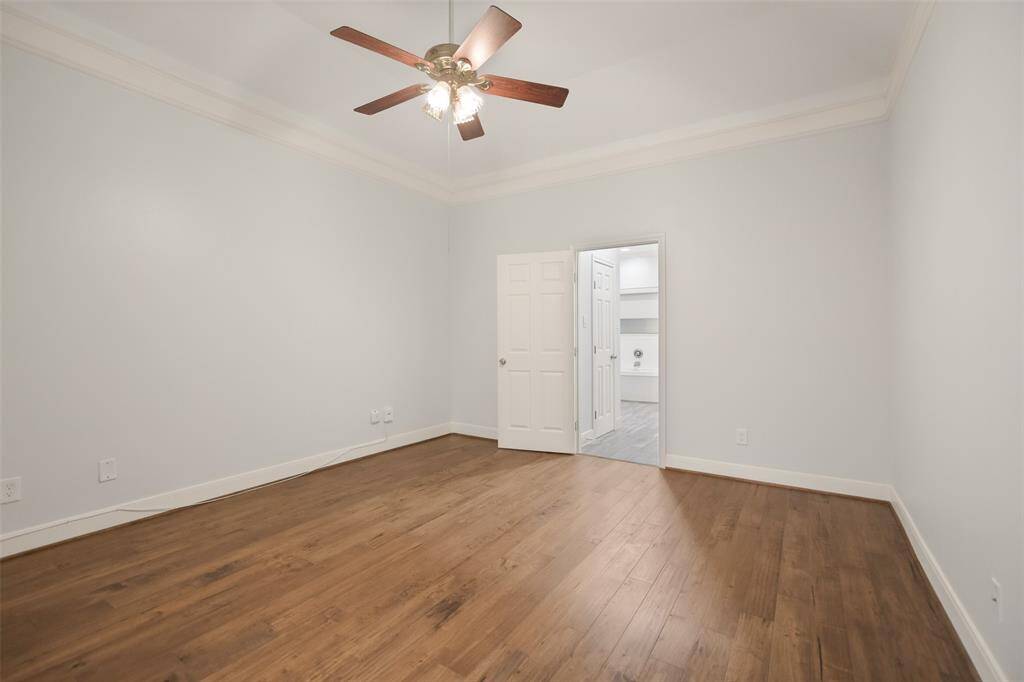 Another glimpse of the primary bedroom, highlighting the private door that leads to the luxurious en-suite bath.