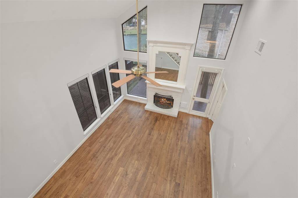 A captivating view of the expansive two-story living room as seen from the second floor, showcasing its impressive height and open design.