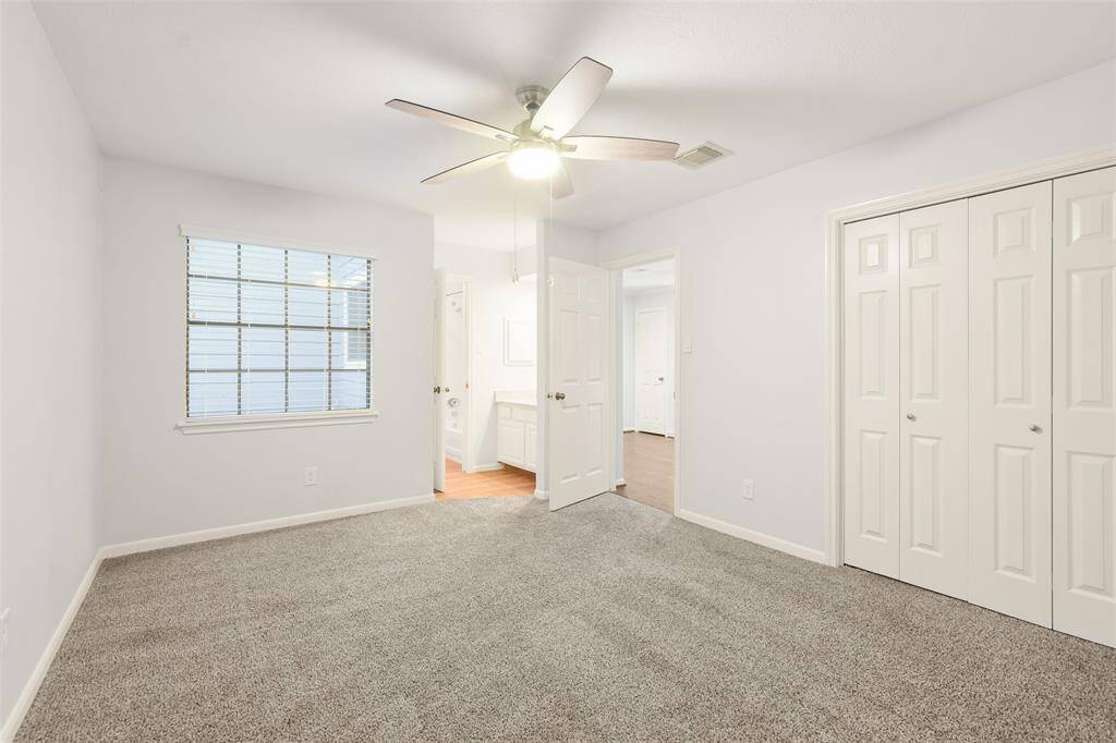 One of the two secondary bedrooms on the second floor, featuring a convenient reach-in closet and direct access to the shared Jack-and-Jill bath.