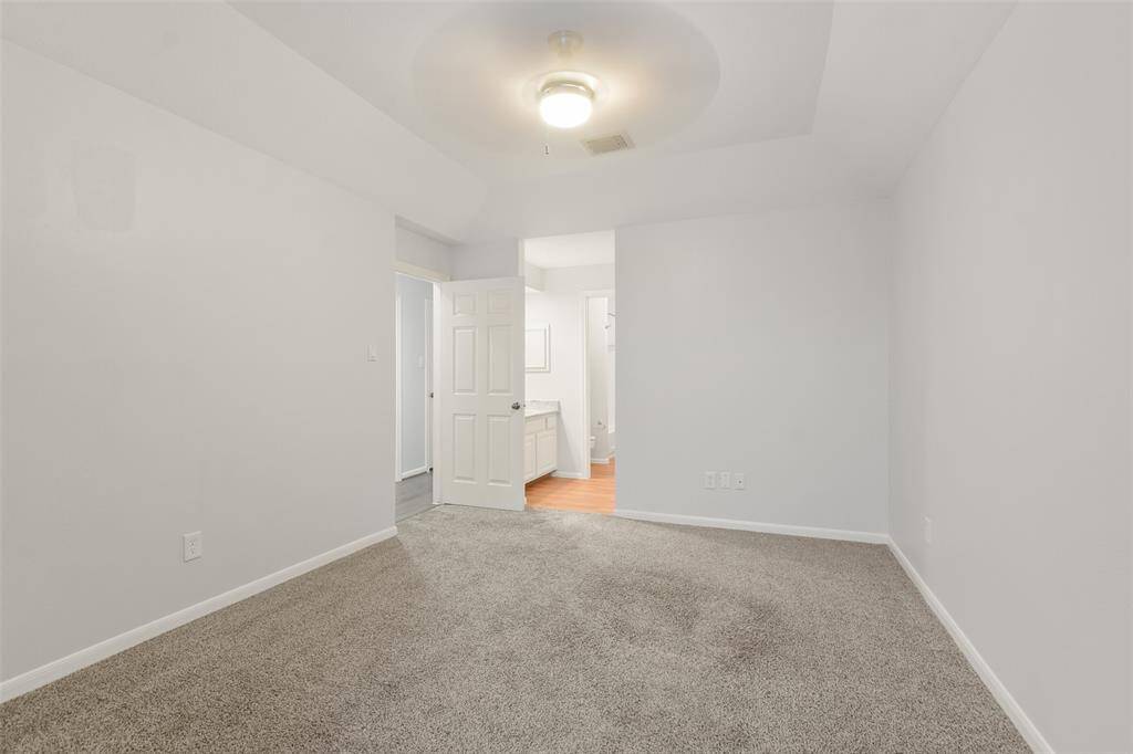 Another angle of this spacious secondary bedroom, highlighting its convenient direct access to the shared Jack-and-Jill bathroom.