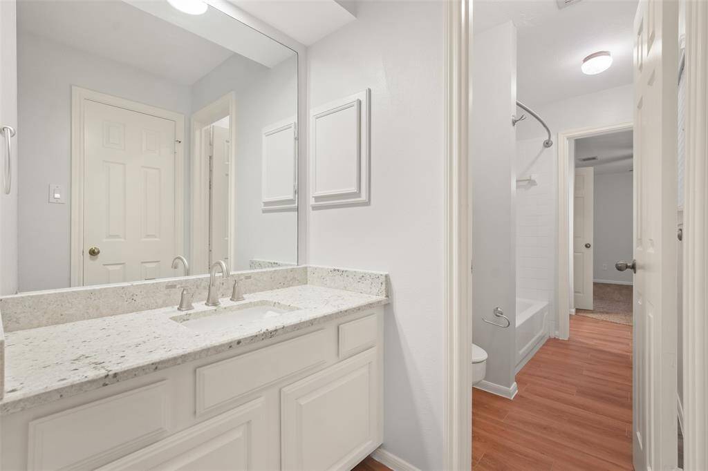 A view this spacious bedroom's Jack-Jill sink area, beautifully designed with granite countertops for a polished and functional touch.