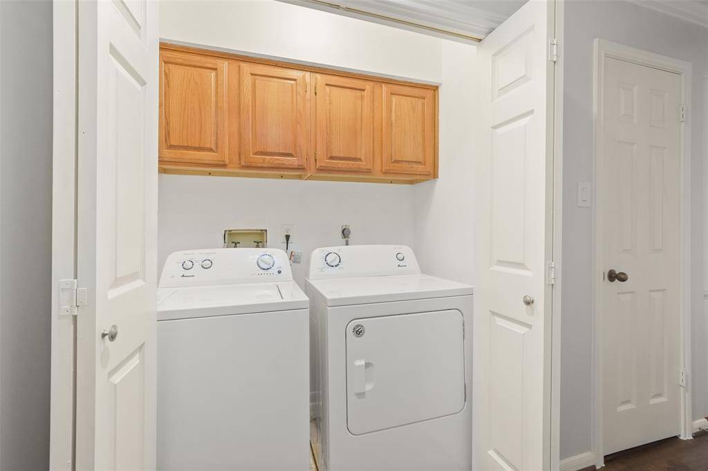 A convenient second-floor laundry area featuring ample storage cabinets, combining functionality with ease of access.