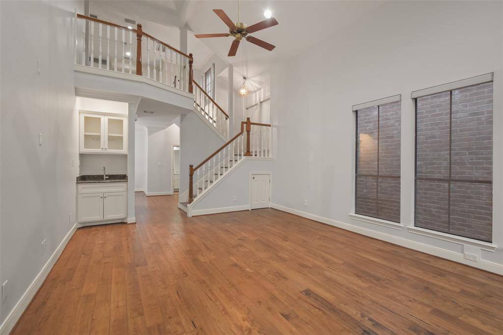 Another charming glimpse of the inviting two-story living room, complete with a cozy ambiance and a convenient wet bar for entertaining.