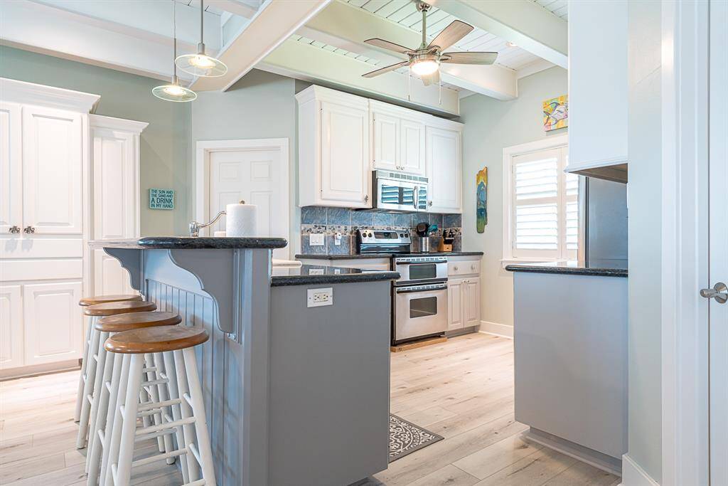 Kitchen with bar stools for additional dining options
