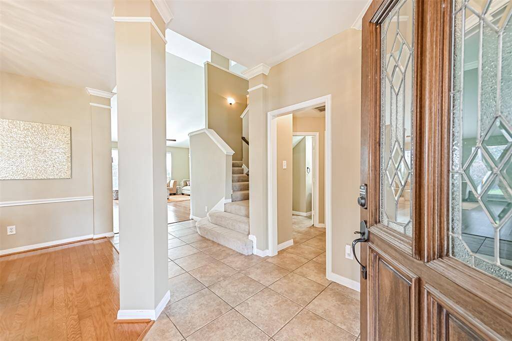 Greeted with a large open foyer separating the formal dining and home office.