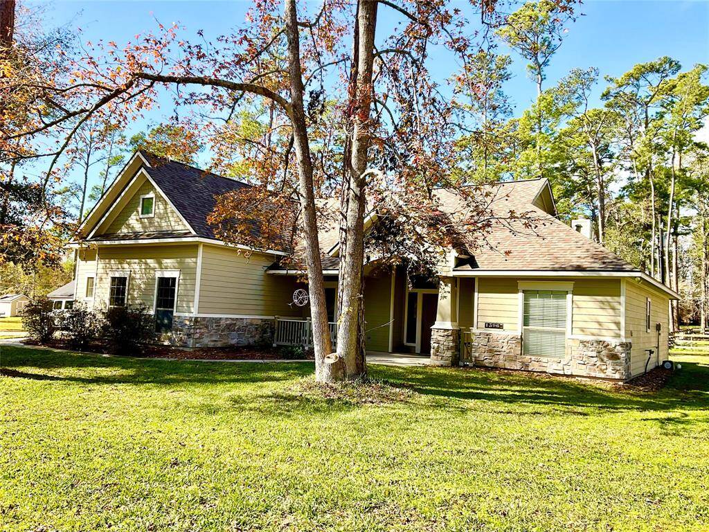 Charming single-story home with a stone and siding exterior set in a lush, wooded environment. Features a spacious front yard and a welcoming porch, perfect for enjoying nature. Ideal for those seeking a serene, picturesque setting.