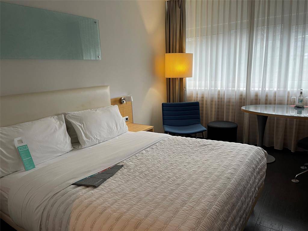 A cozy secondary bedroom offering natural light and a warm, inviting atmosphere.