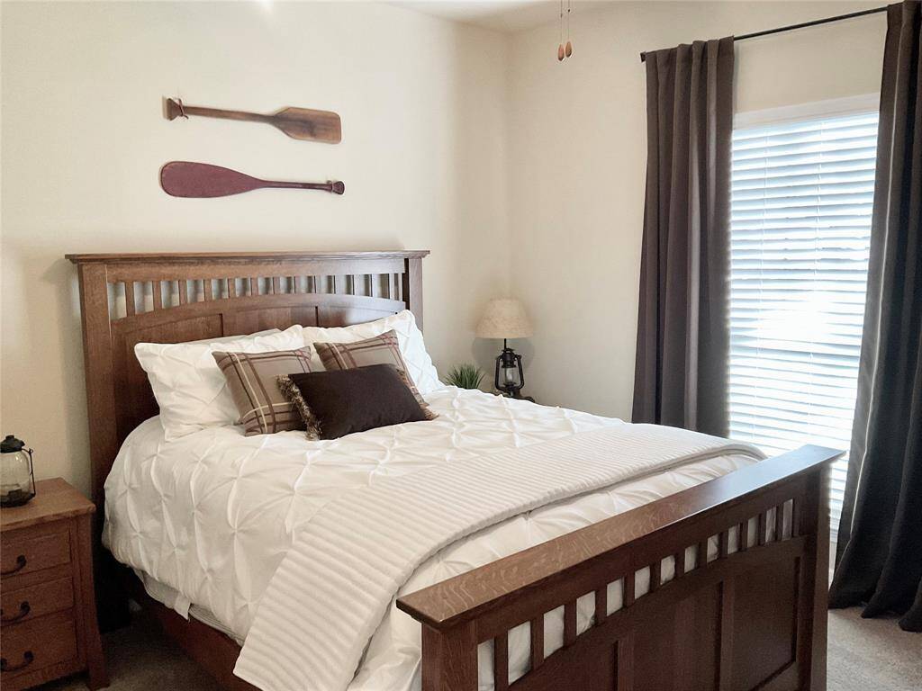 A third secondary bedroom would also make a fantastic home office. Natural light streams in through the windows with blinds, completing the inviting atmosphere.