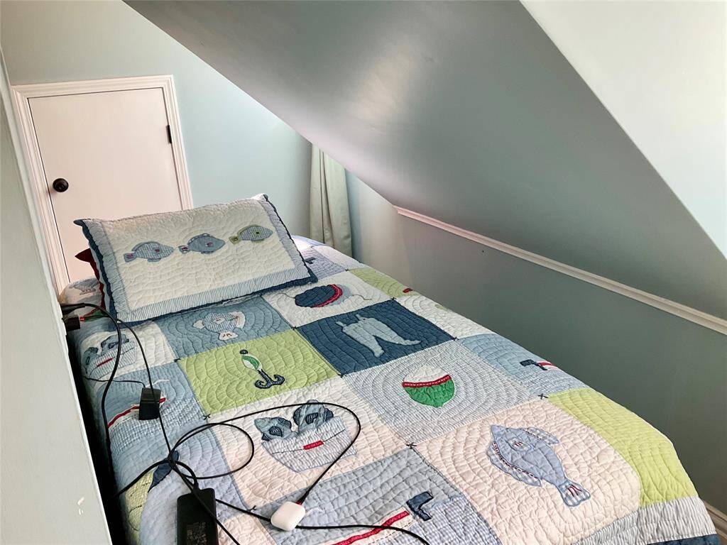 This cozy attic bedroom features a sloped ceiling and a hide away!  I bet this is one of 5 favorite rooms in the house.