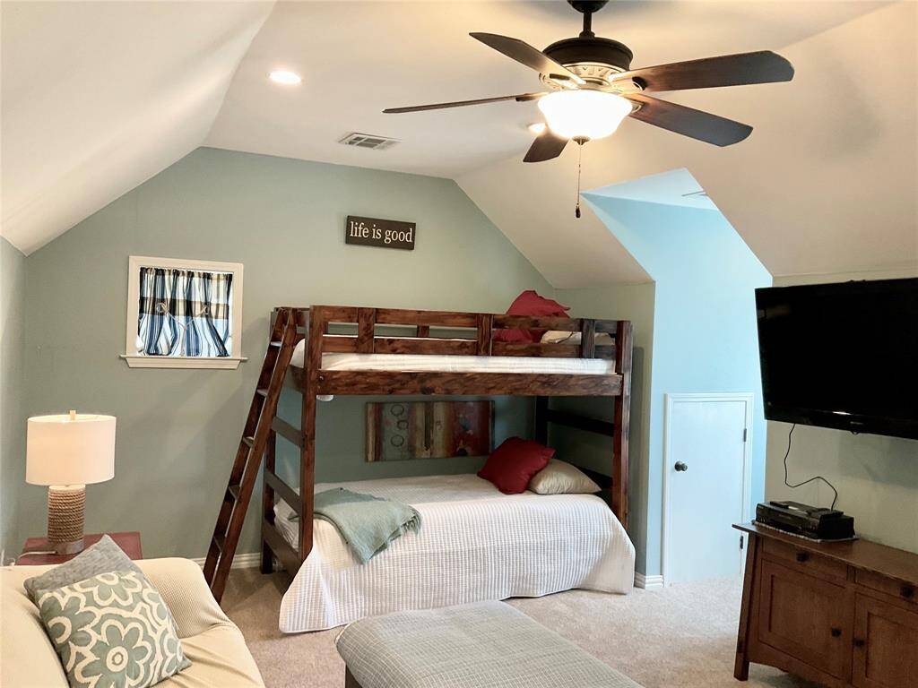 Cozy room is well-lit with a ceiling fan and has a calming color palette, ideal for a relaxing retreat or an invaluable flex room for your enjoyment.